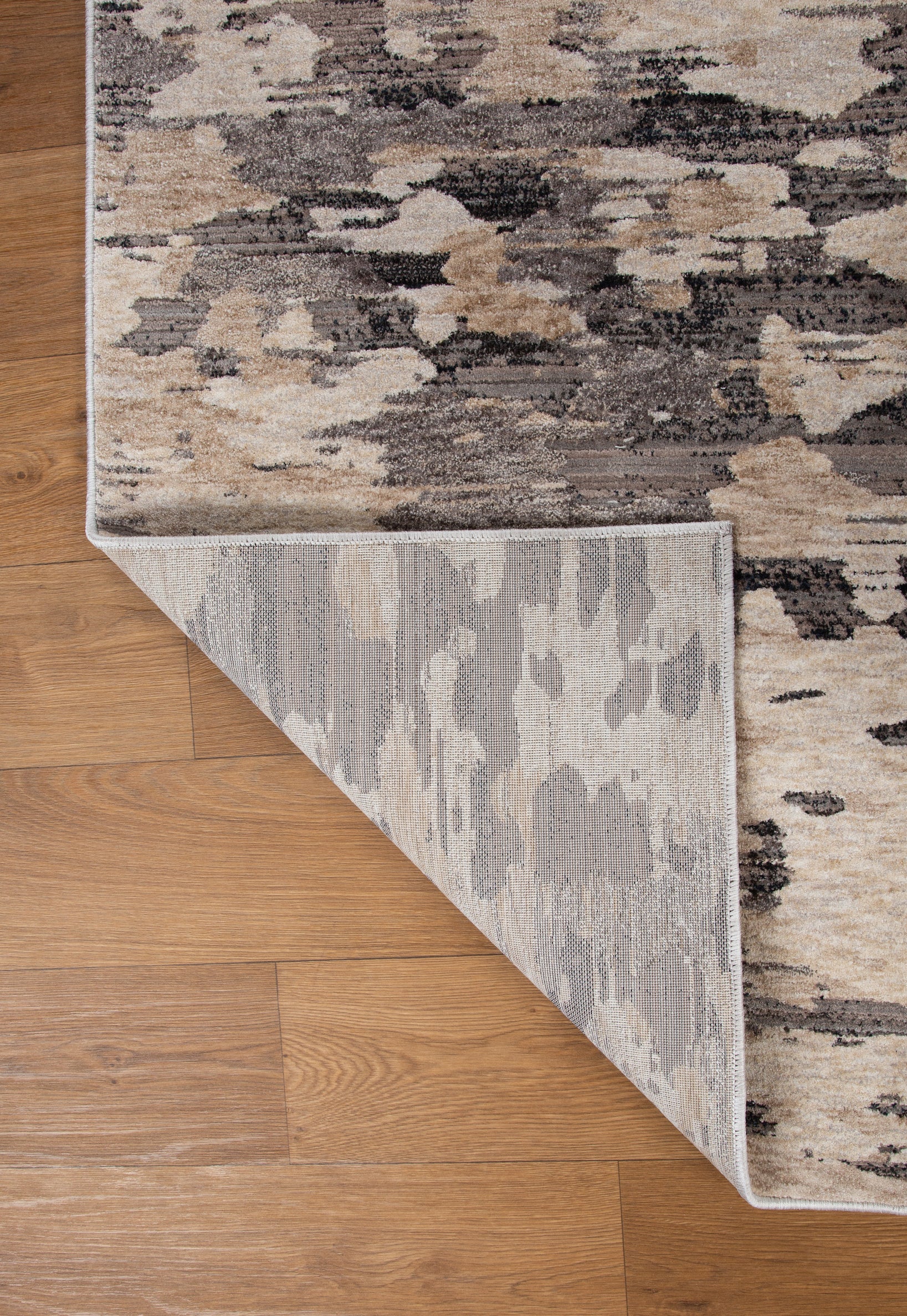 Blue book on gray and white striped wool rug with textured surface