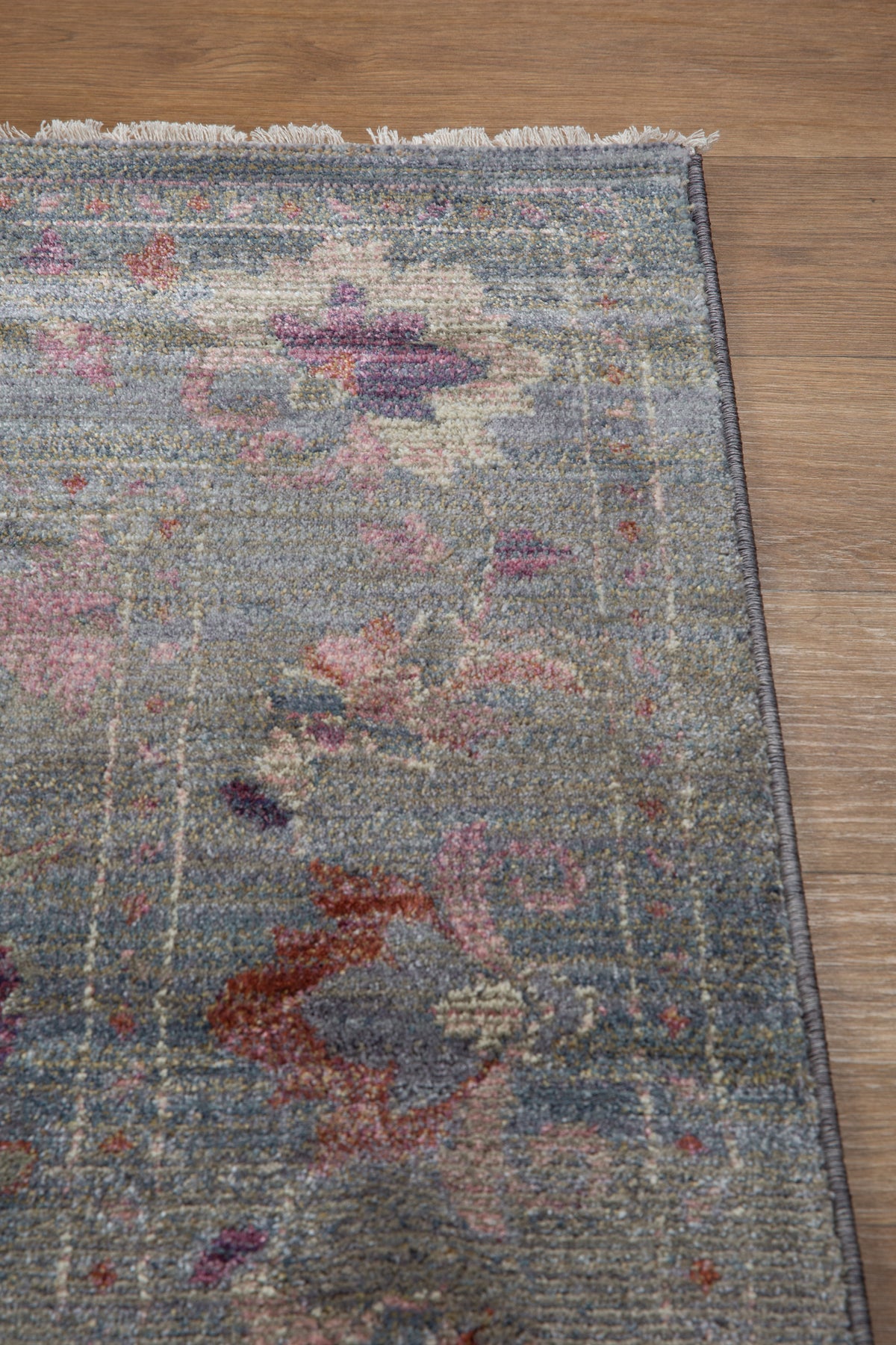 Vintage floral rug with faded botanical pattern in muted blue and rose tones