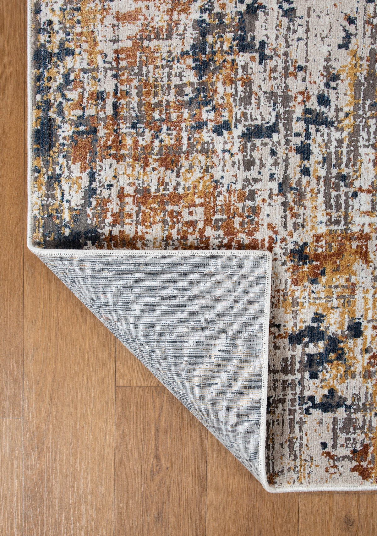 Abstract distressed rug with navy, rust, and cream textured pattern