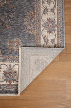 Gray traditional rug with ornate cream border and floral damask pattern
