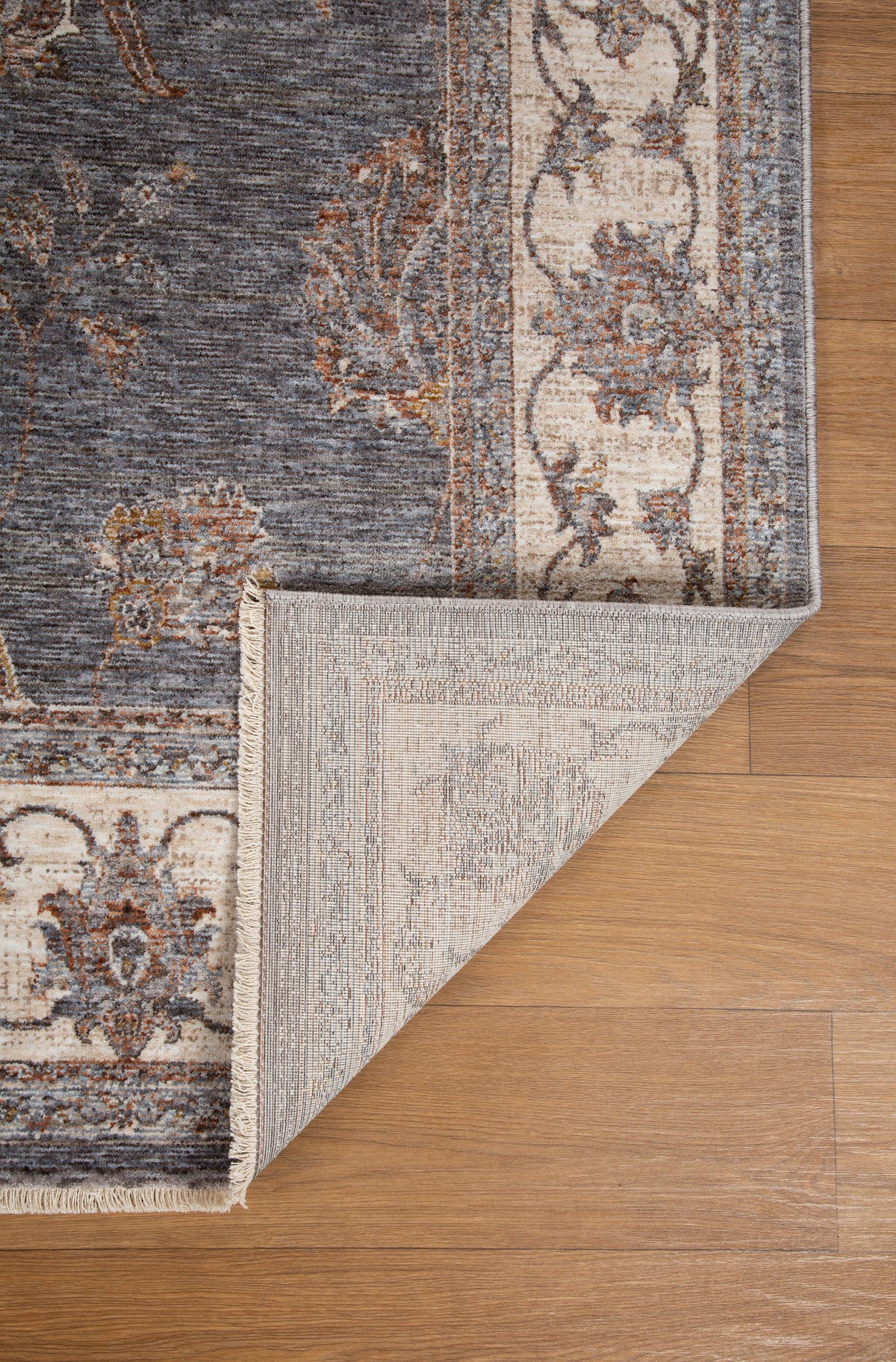 Gray traditional rug with ornate cream border and floral damask pattern