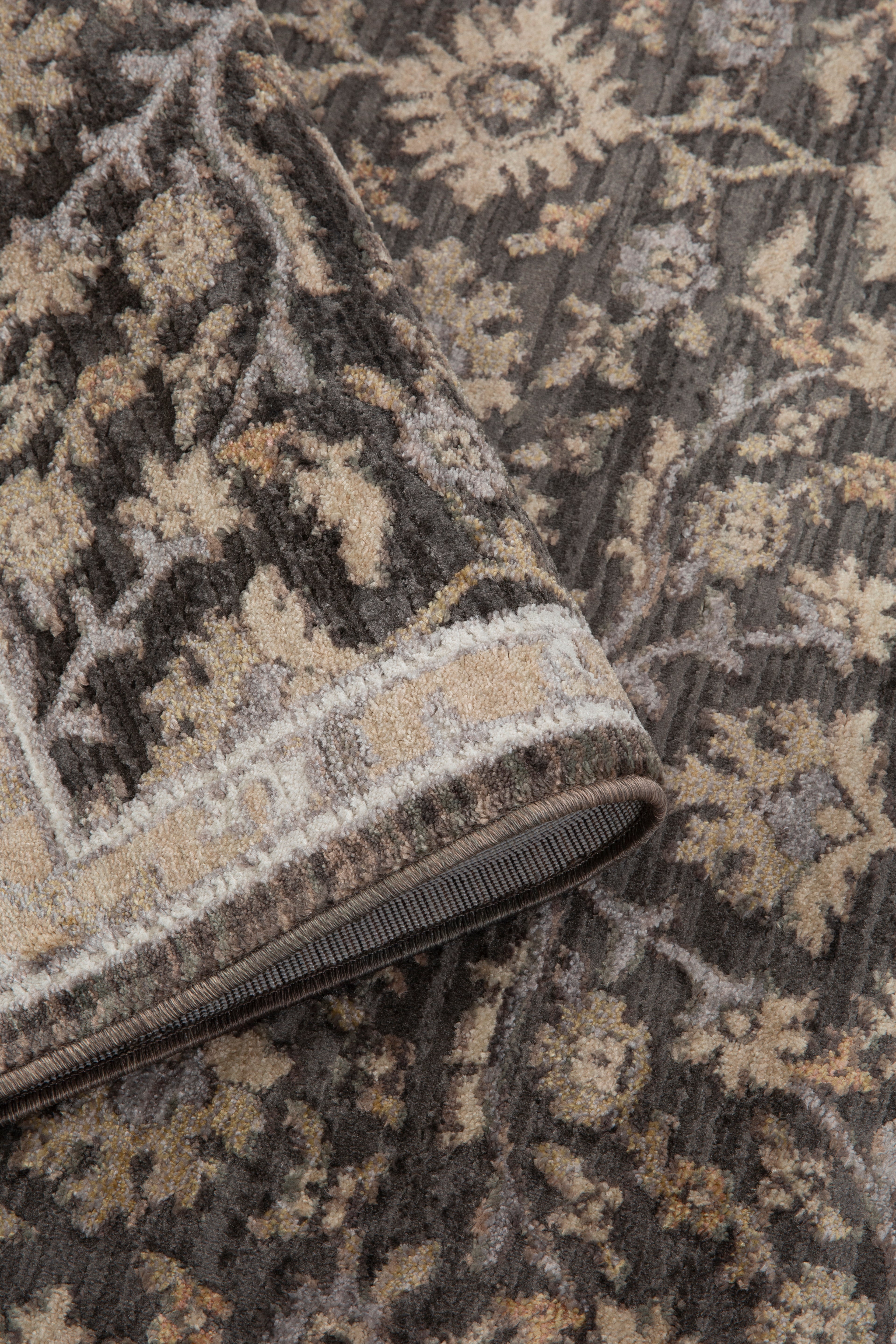 Charcoal and beige damask patterned rug with ornate floral motifs and border
