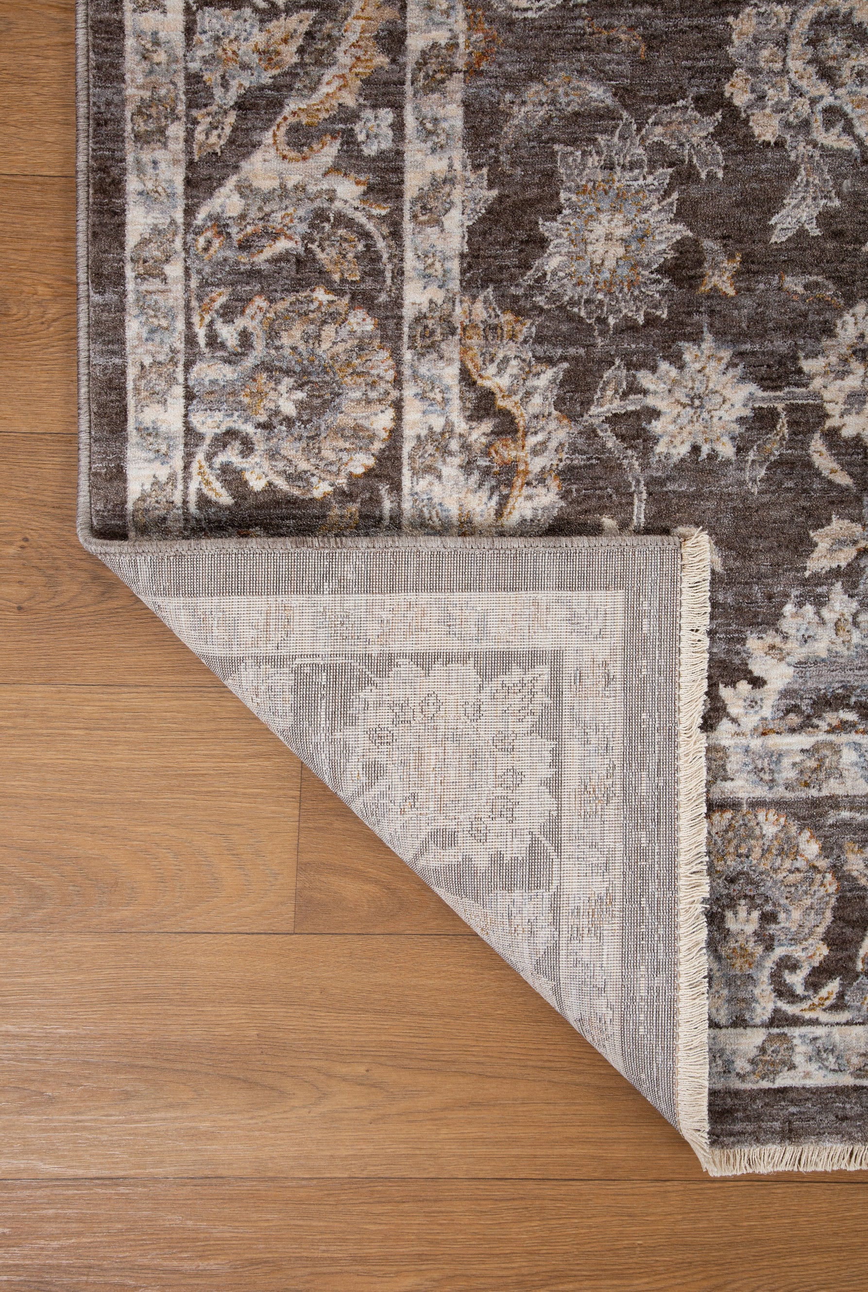 Traditional floral rug with brown center, ornate cream border and botanical pattern design