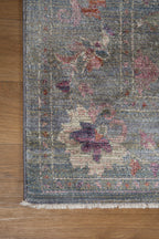Vintage floral rug with faded botanical pattern in muted blue and rose tones