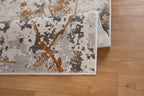 Modern distressed rug with gold, gray and cream abstract splatter pattern design