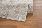 Modern geometric patterned rug in soft beige, grey and gold tones