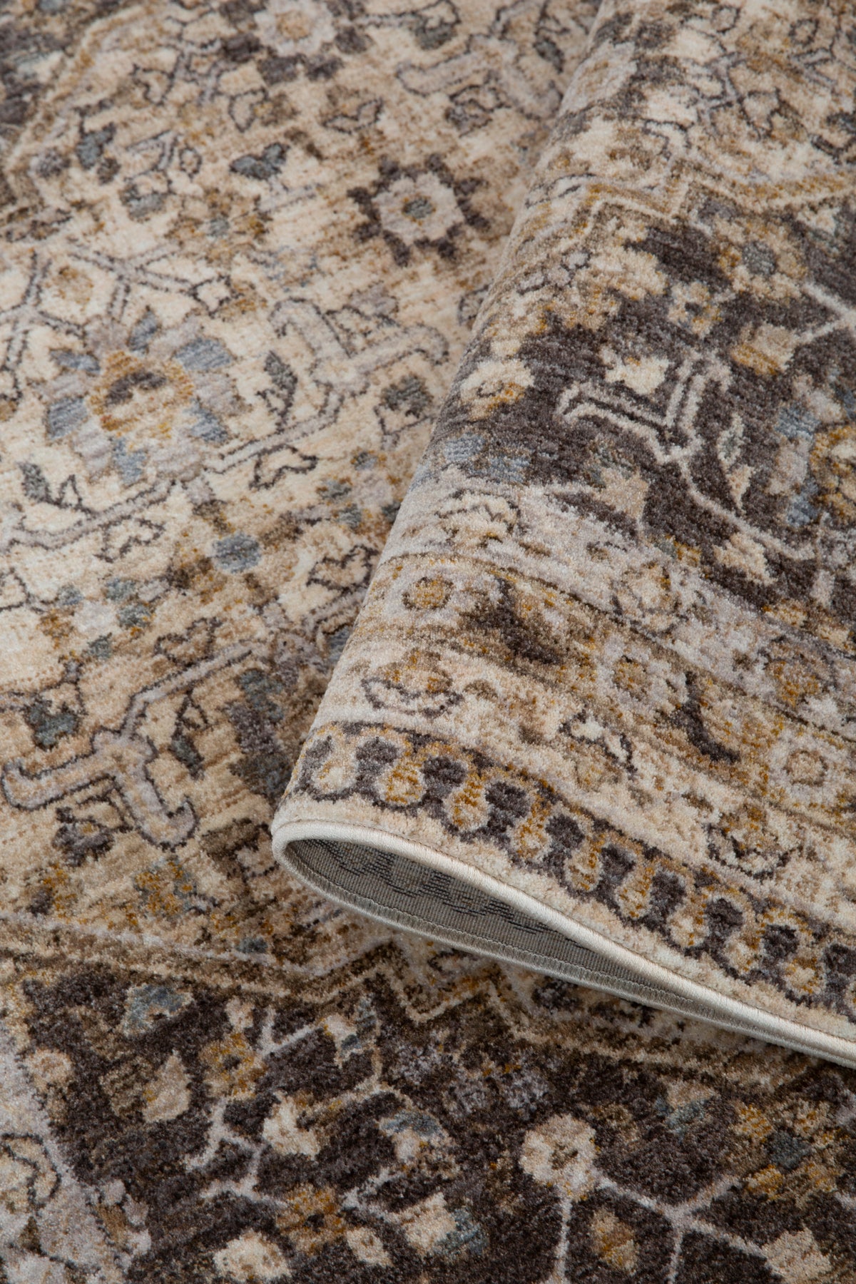 Vintage-style area rug with beige and brown geometric patterns and ornate borders