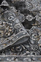 Ornate Persian-style rug with symmetrical medallion pattern in black, gray and cream tones