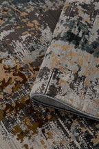 Abstract distressed rug with gold, gray, and black splatter pattern design