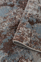 Modern distressed rug with brown, cream and blue abstract texture pattern