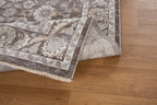 Traditional floral rug with brown center, ornate cream border and botanical pattern design