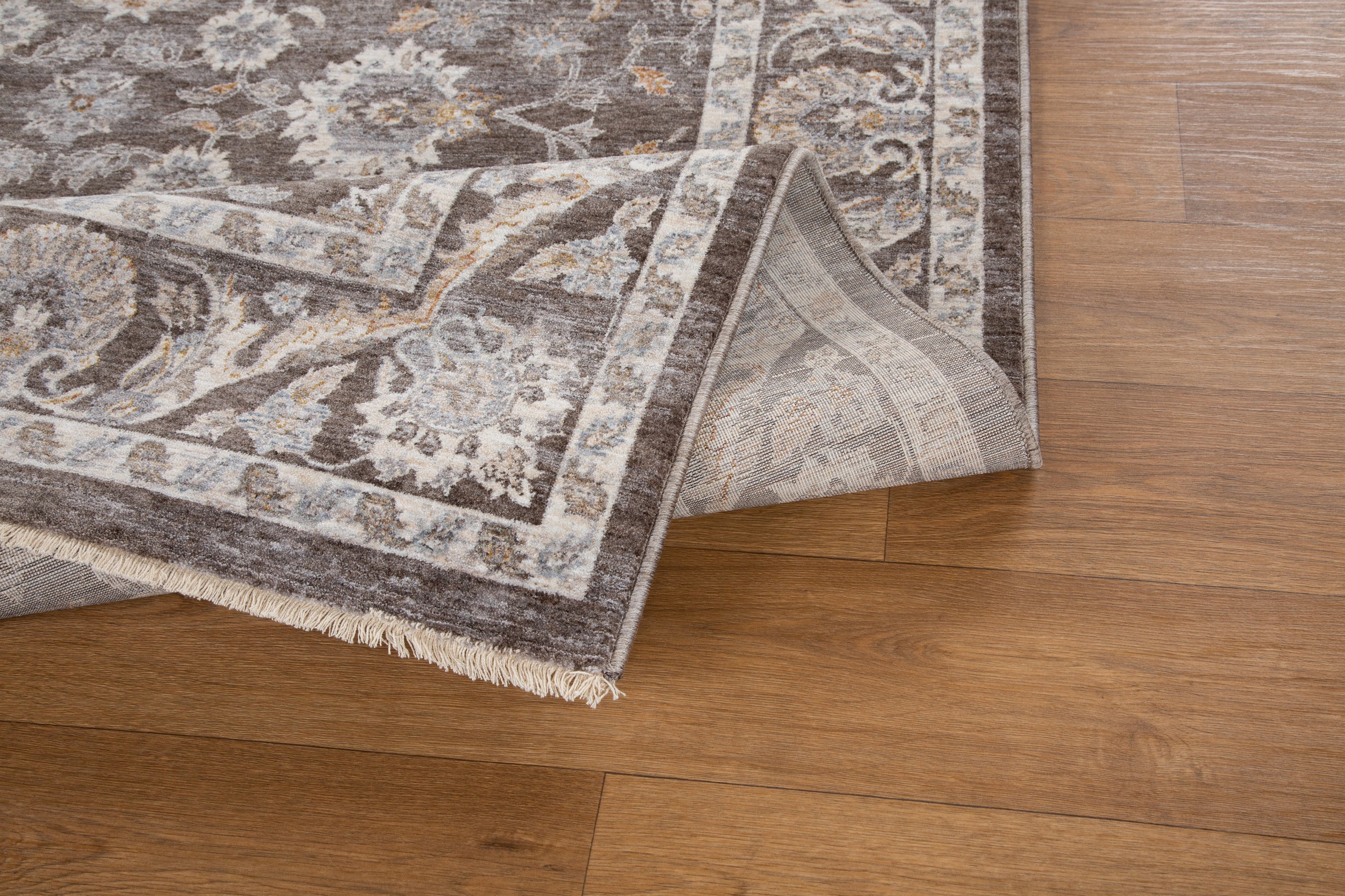 Traditional floral rug with brown center, ornate cream border and botanical pattern design