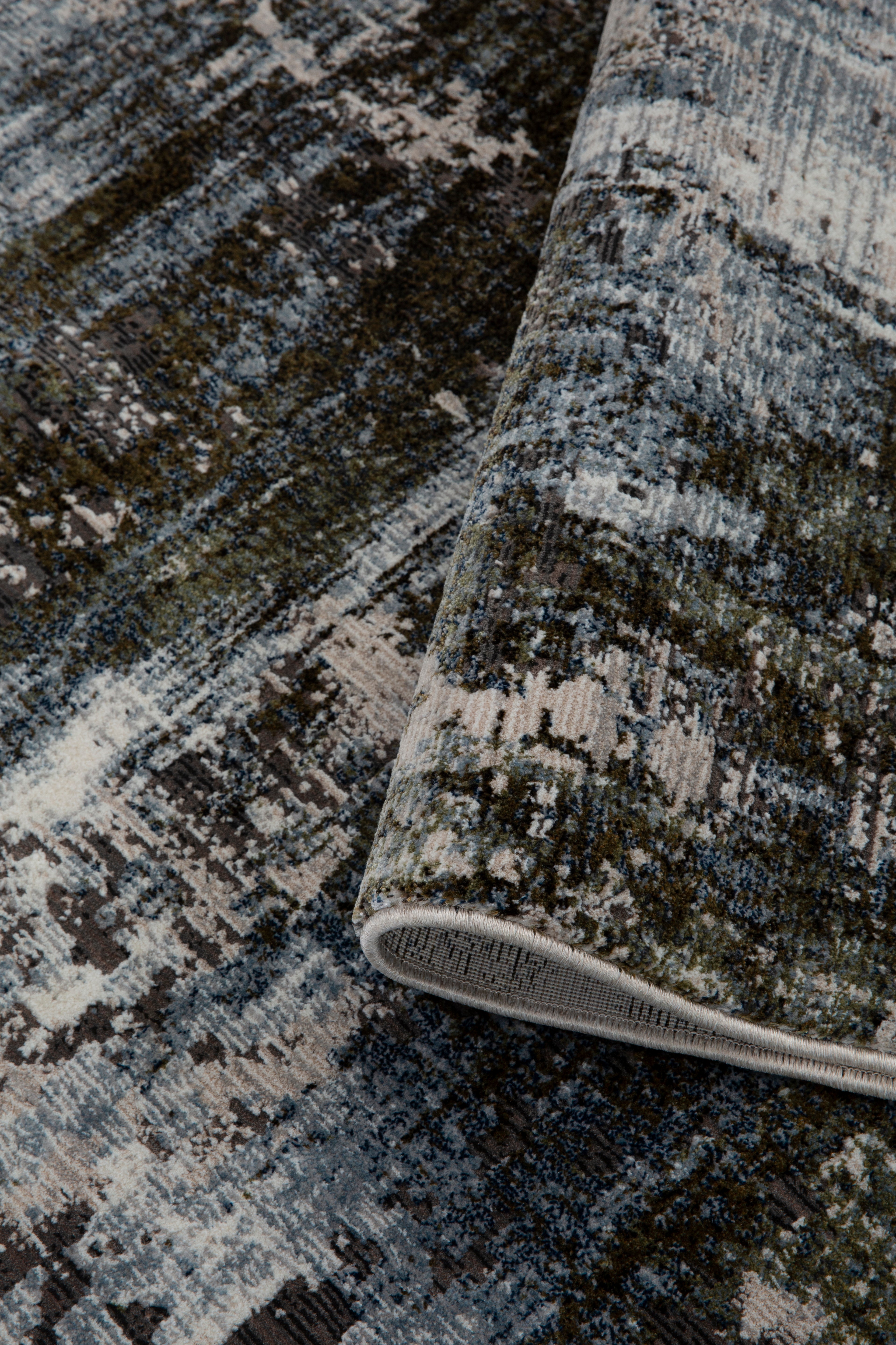 Abstract distressed rug with blue, grey and white textured pattern