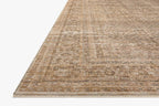 Beige traditional area rug with ornate border and distressed vintage pattern