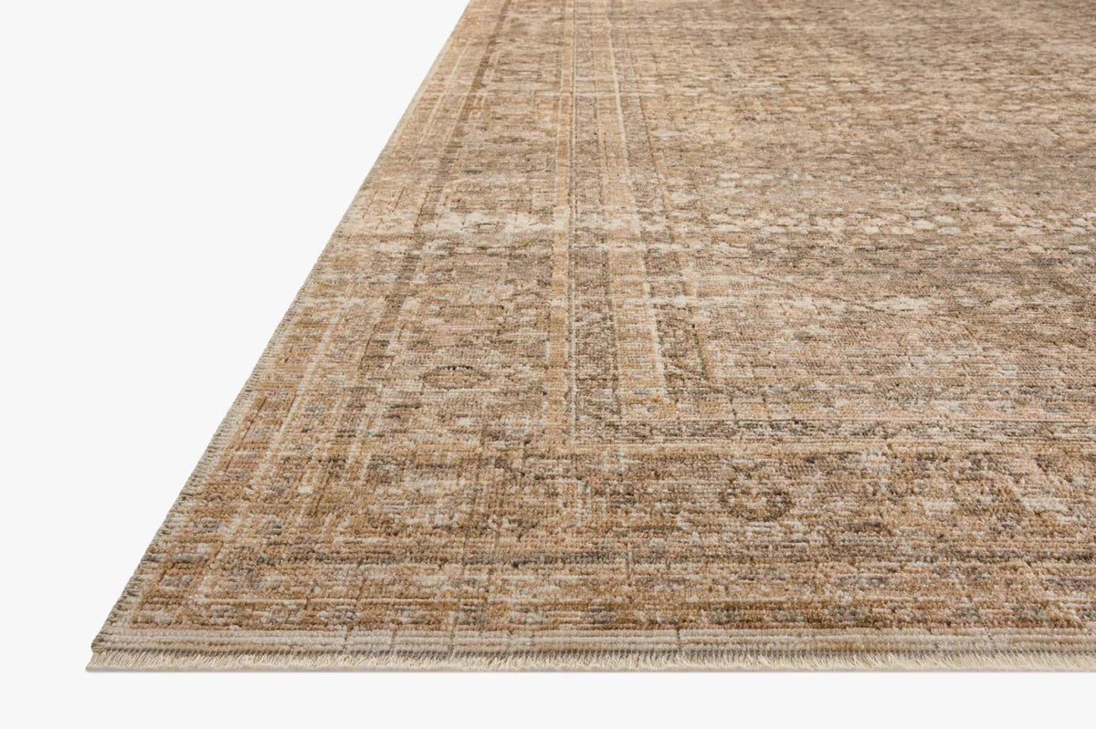 Beige traditional area rug with ornate border and distressed vintage pattern