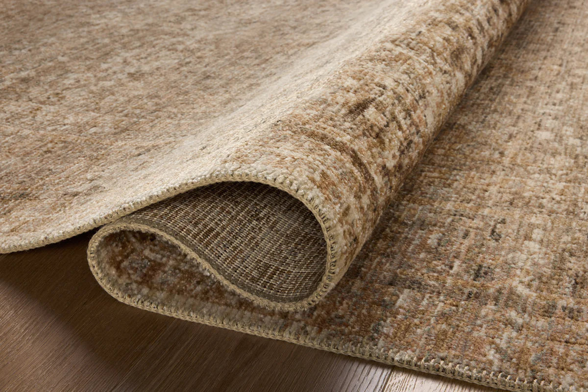 Beige traditional area rug with ornate border and distressed vintage pattern