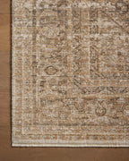 Beige traditional area rug with ornate border and distressed vintage pattern