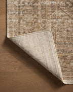 Beige traditional area rug with ornate border and distressed vintage pattern