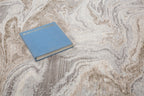 Beige and taupe marbled swirl pattern area rug with textured finish