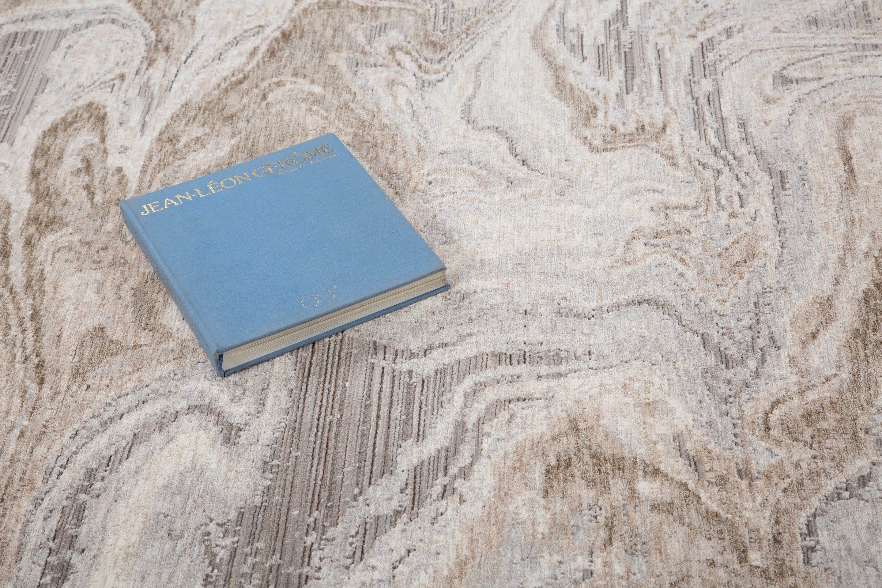 Beige and taupe marbled swirl pattern area rug with textured finish