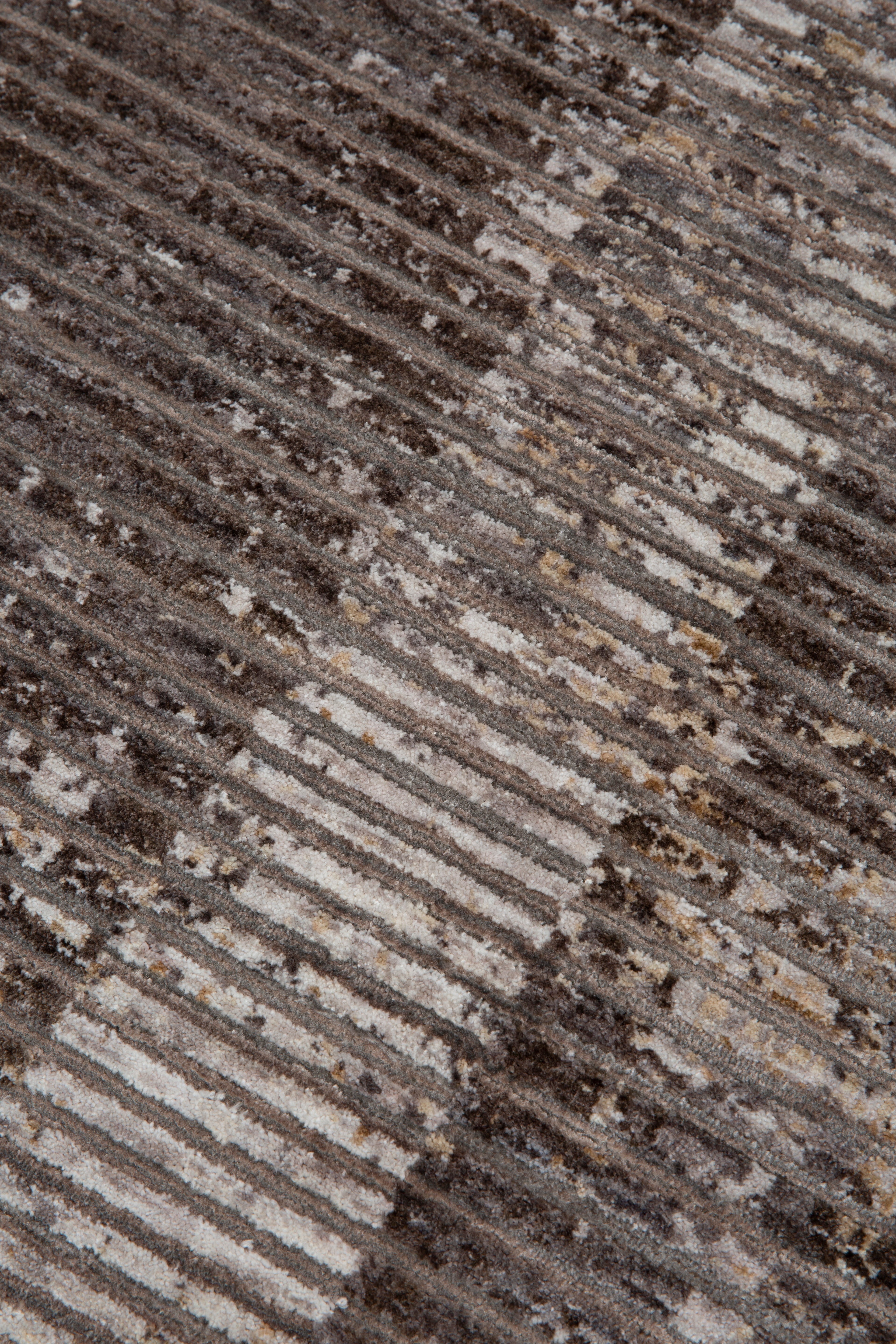 Modern geometric striped rug in grey, taupe and cream tones with distressed texture