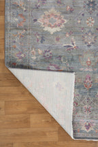 Vintage floral rug with faded botanical pattern in muted blue and rose tones