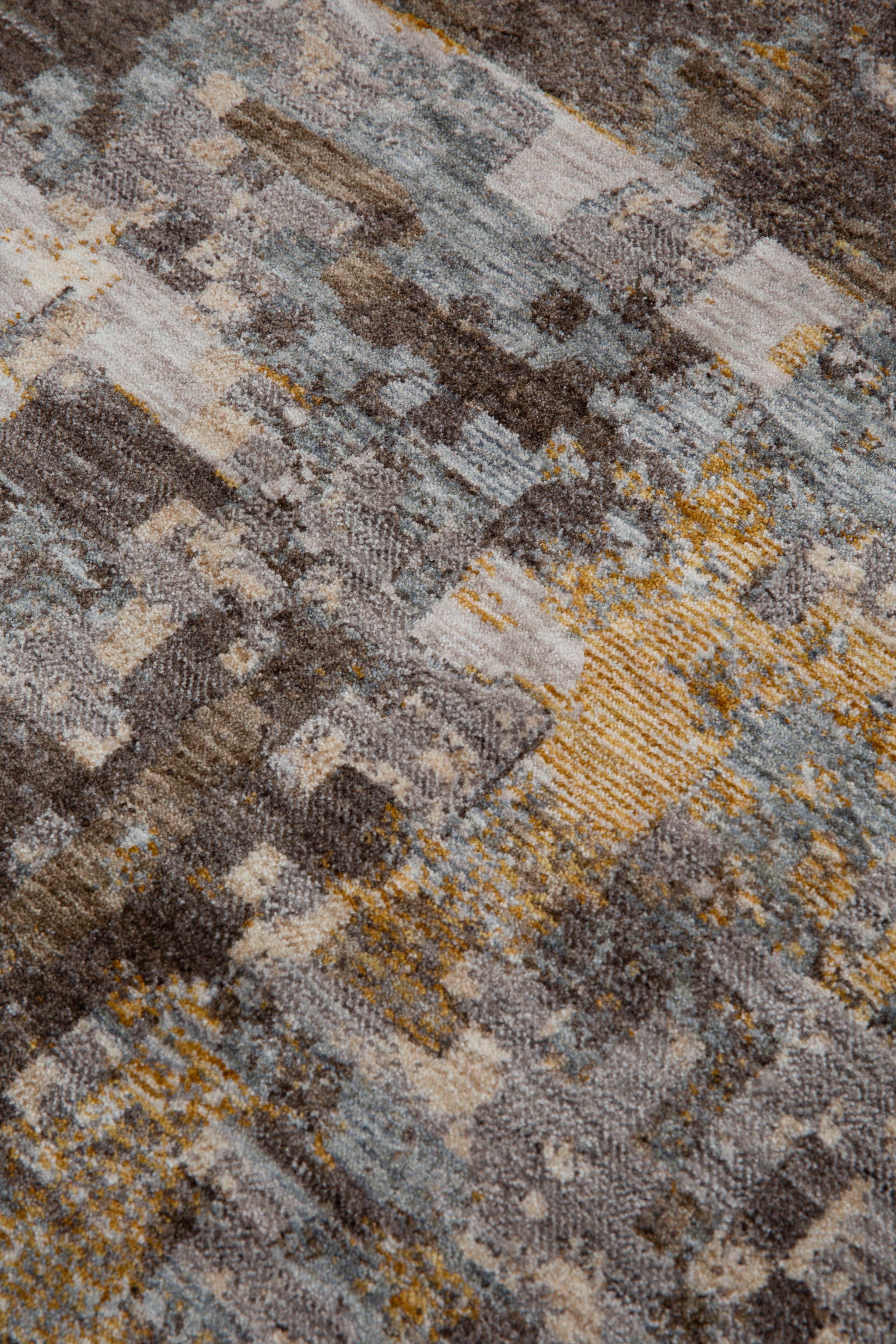 Abstract distressed rug with gold, grey, and brown pixelated pattern texture