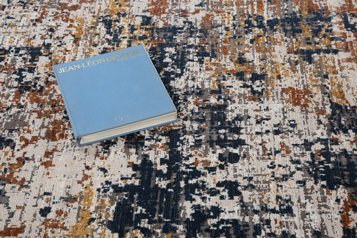 Abstract distressed rug with navy, rust, and cream textured pattern