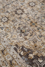 Vintage-style area rug with beige and brown geometric patterns and ornate borders