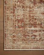Vintage-style rug with faded terracotta and beige distressed floral pattern throughout