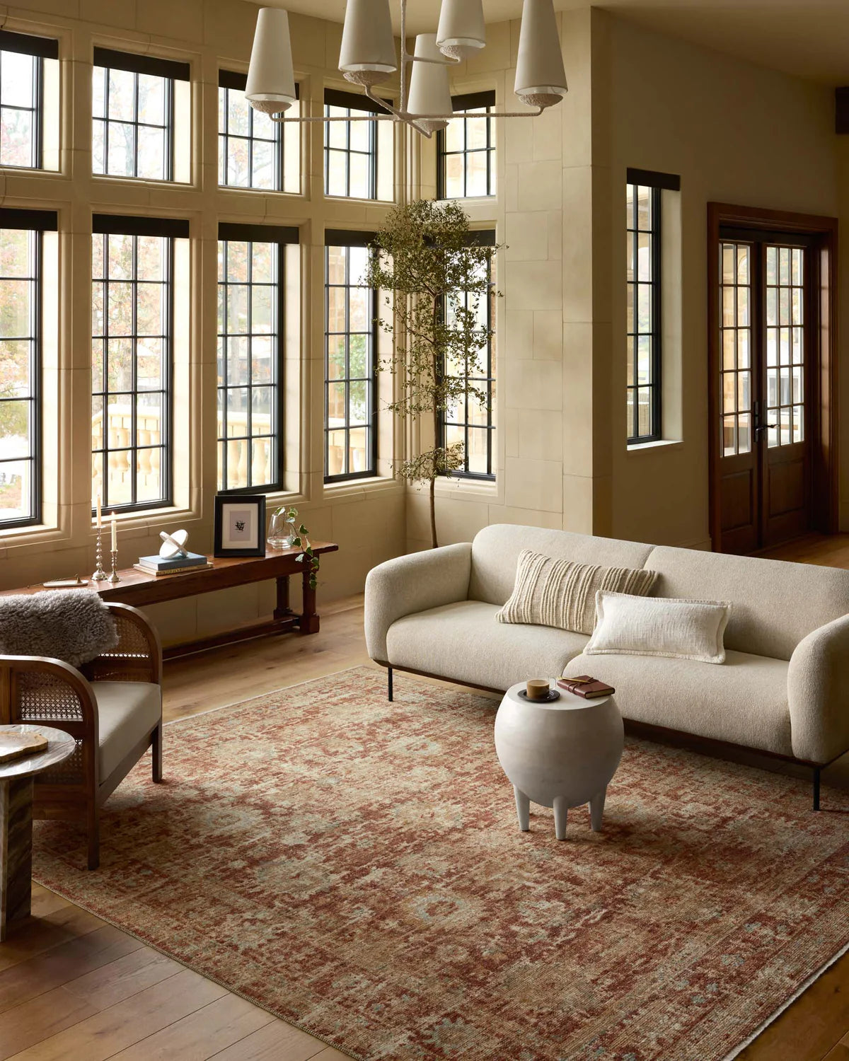 Vintage-style rug with faded terracotta and beige distressed floral pattern throughout
