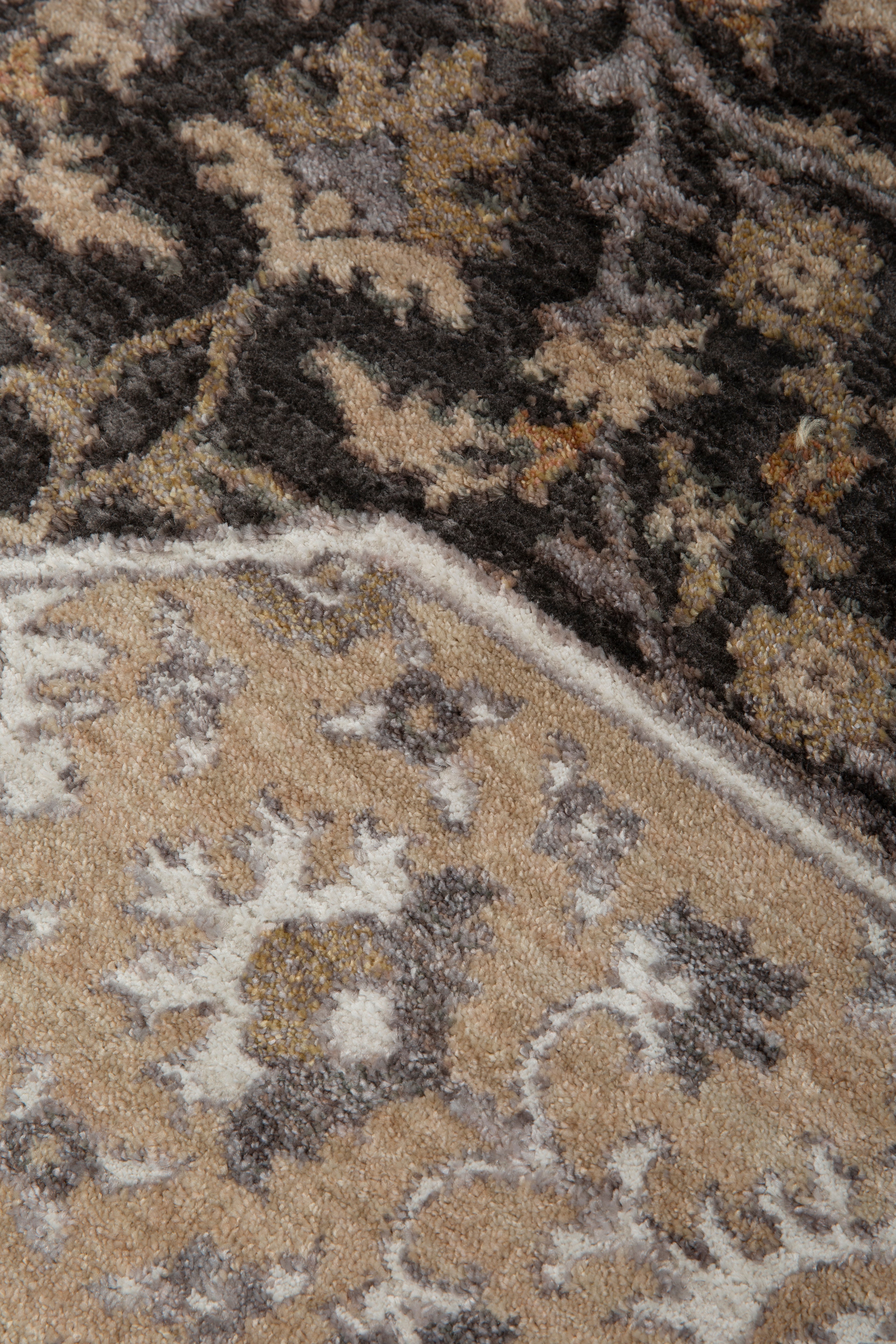 Charcoal and beige damask patterned rug with ornate floral motifs and border