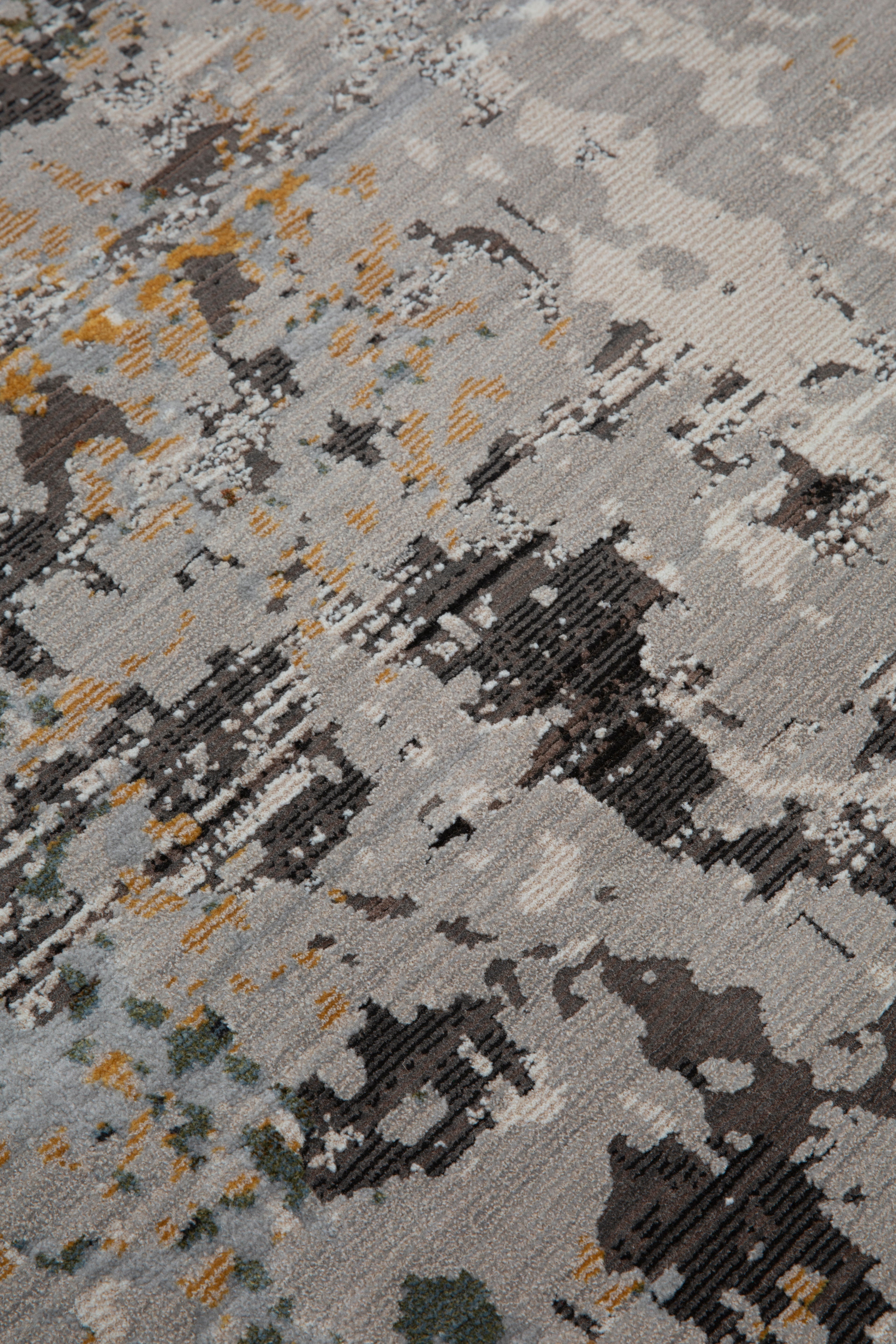 Abstract distressed rug with gold, gray, and black splatter pattern design