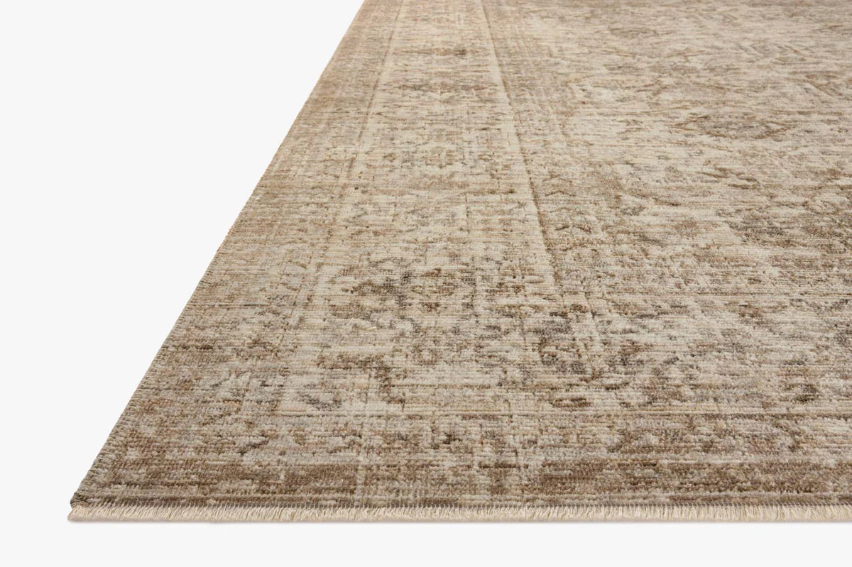 Beige traditional Persian-style rug with intricate geometric and floral patterns throughout