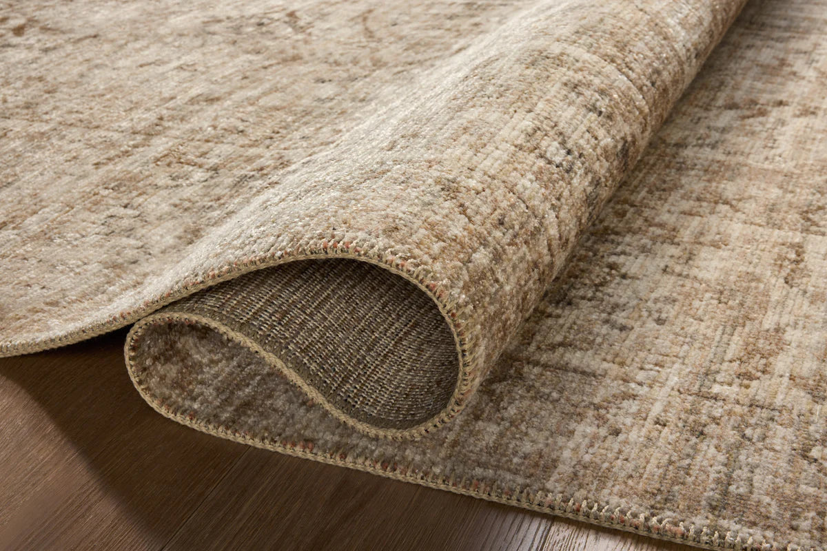 Beige traditional Persian-style rug with intricate geometric and floral patterns throughout