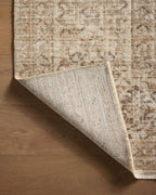Beige traditional Persian-style rug with intricate geometric and floral patterns throughout