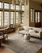 Vintage-style area rug with faded blue and beige geometric patterns throughout