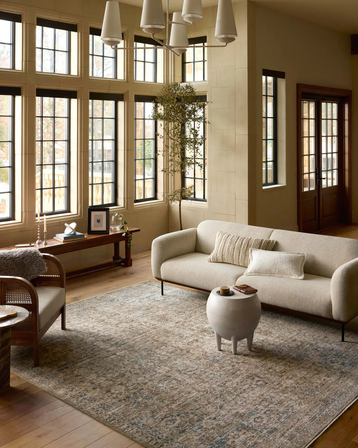 Vintage-style area rug with faded blue and beige geometric patterns throughout