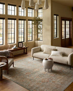 Vintage-style rug with faded rust and cream patterns on soft green background