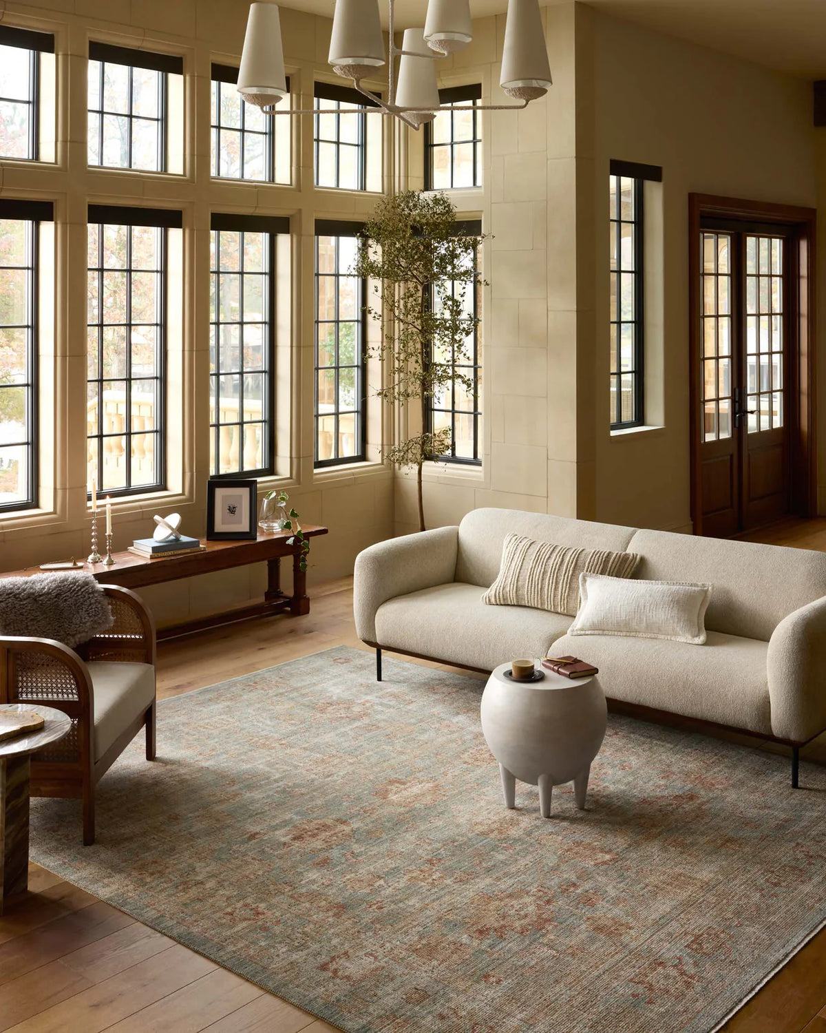 Vintage-style rug with faded rust and cream patterns on soft green background