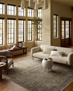 Vintage-style area rug with faded blue and beige geometric patterns throughout