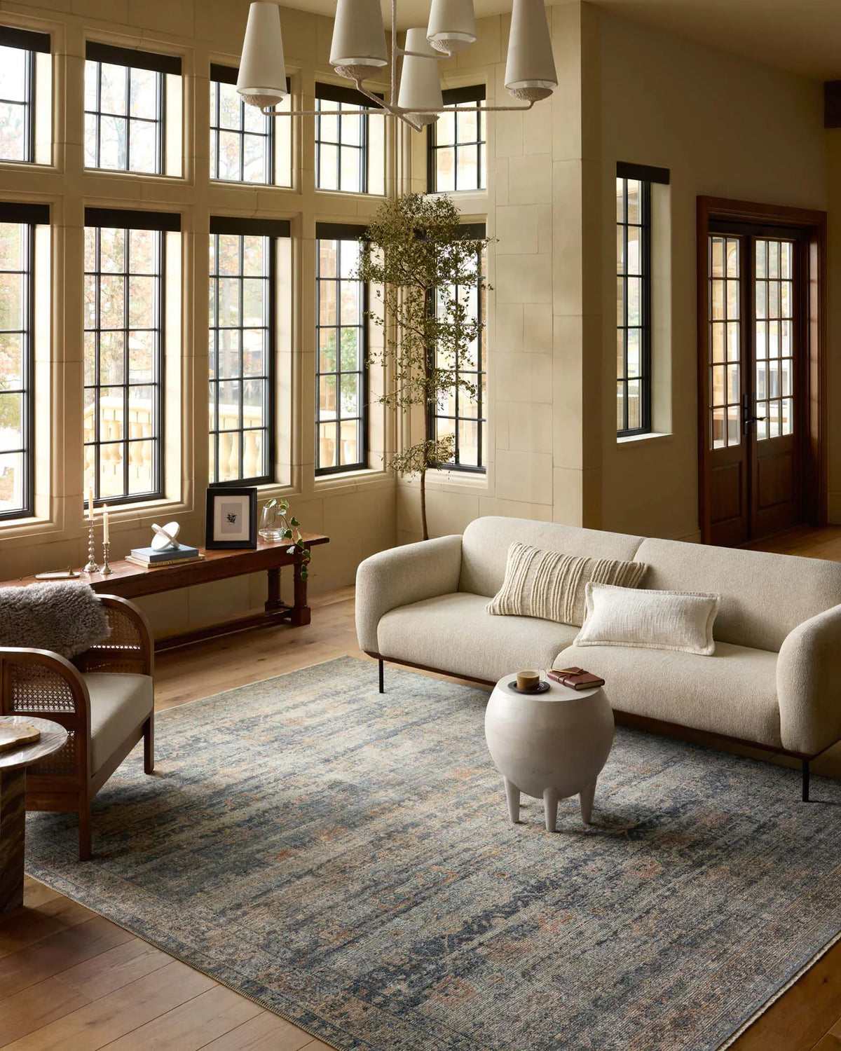 Vintage-style area rug with distressed geometric patterns in blue, tan and grey tones