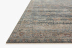 Vintage-style area rug with distressed geometric patterns in blue, tan and grey tones