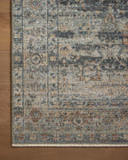 Vintage-style area rug with distressed geometric patterns in blue, tan and grey tones