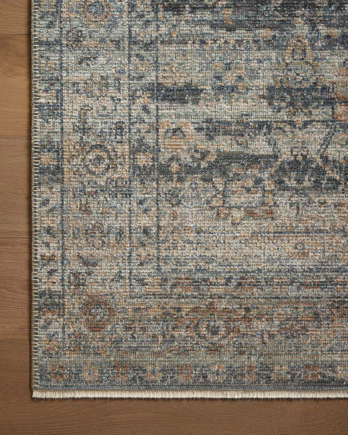 Vintage-style area rug with distressed geometric patterns in blue, tan and grey tones