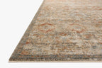 Vintage-style area rug with distressed red and beige geometric patterns on neutral background