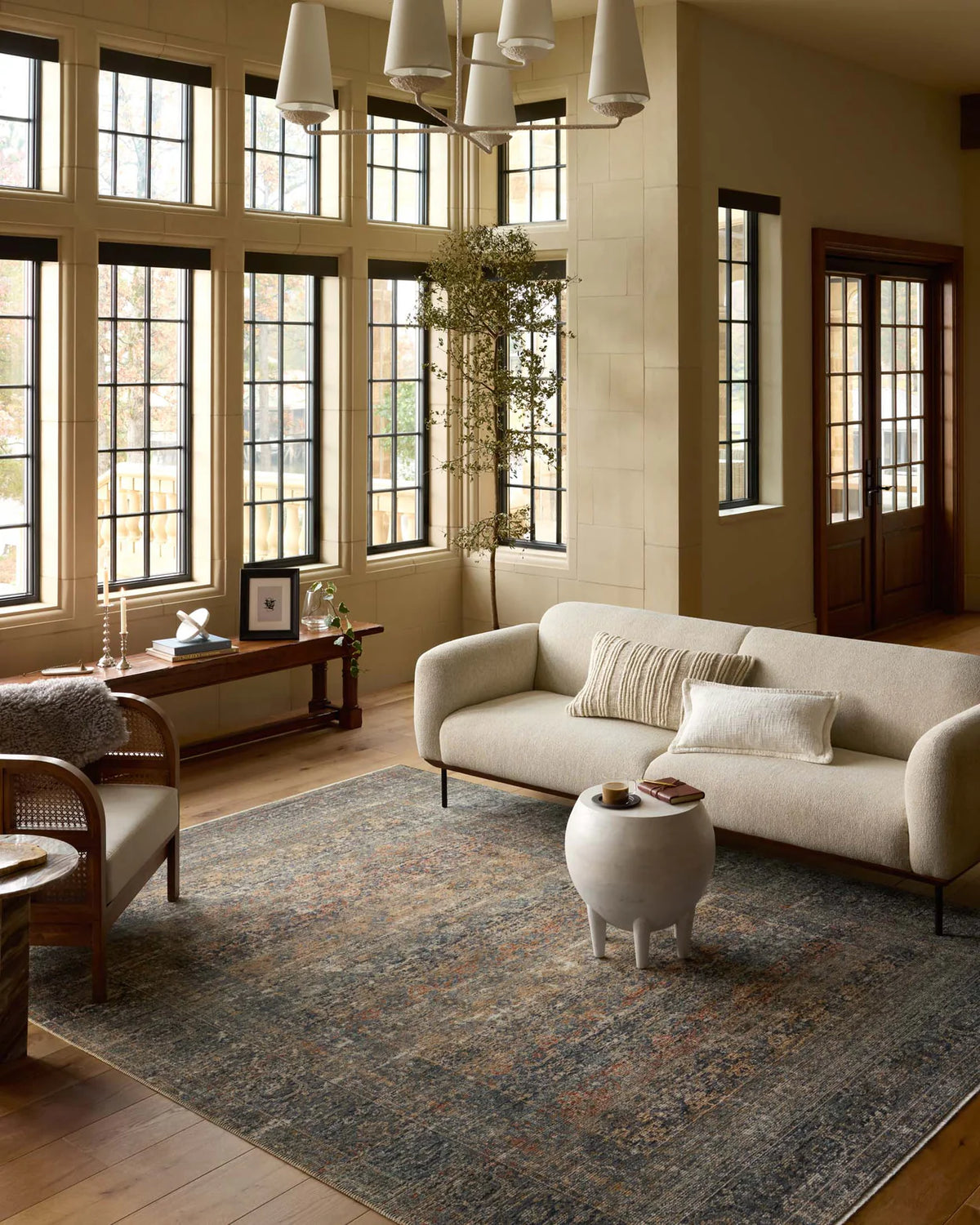 Vintage-style distressed rug with muted grey, tan, and rust tones throughout