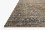 Vintage-style distressed rug with muted grey, tan, and rust tones throughout