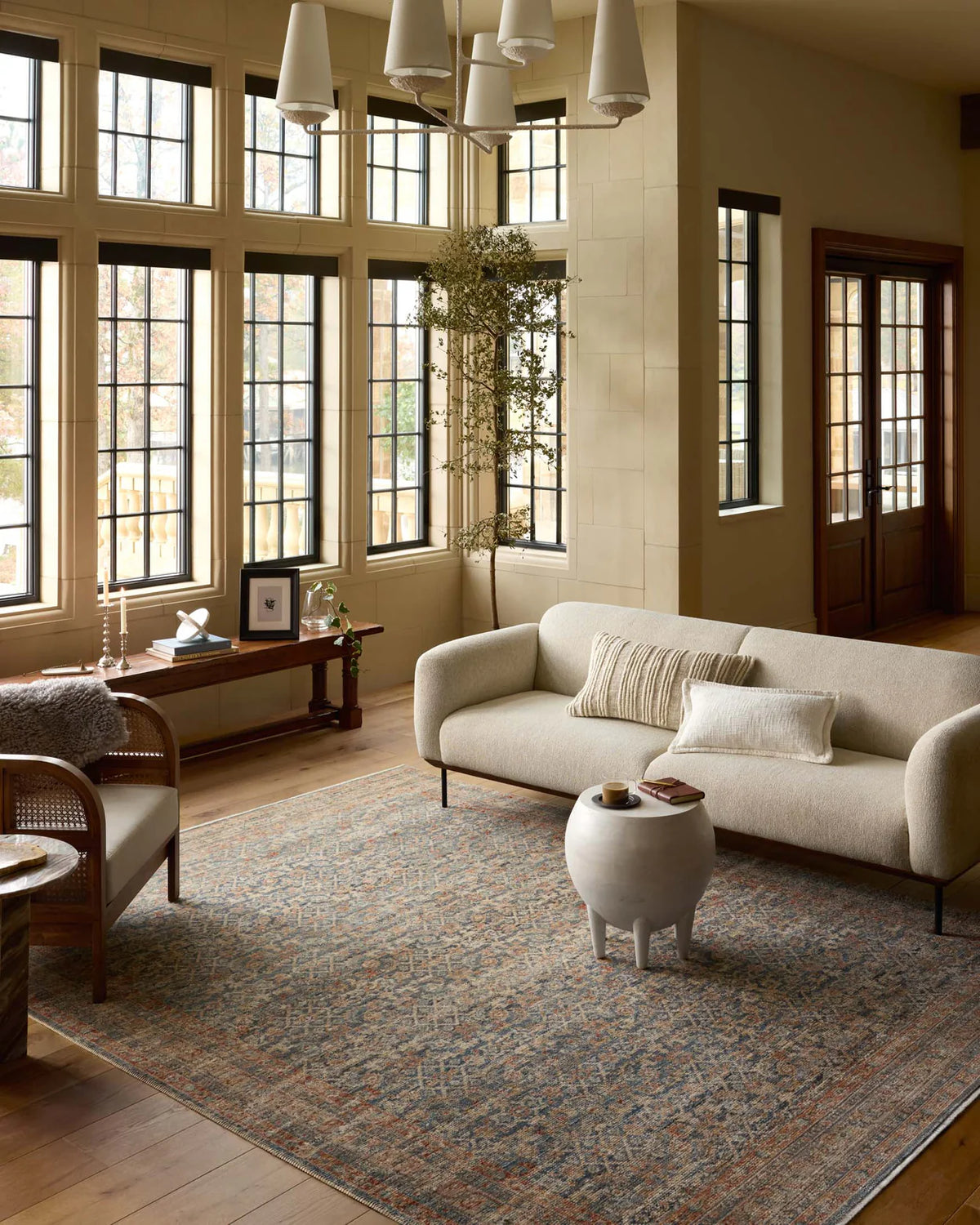 Vintage-style rug with intricate geometric patterns in blue, rust and cream tones