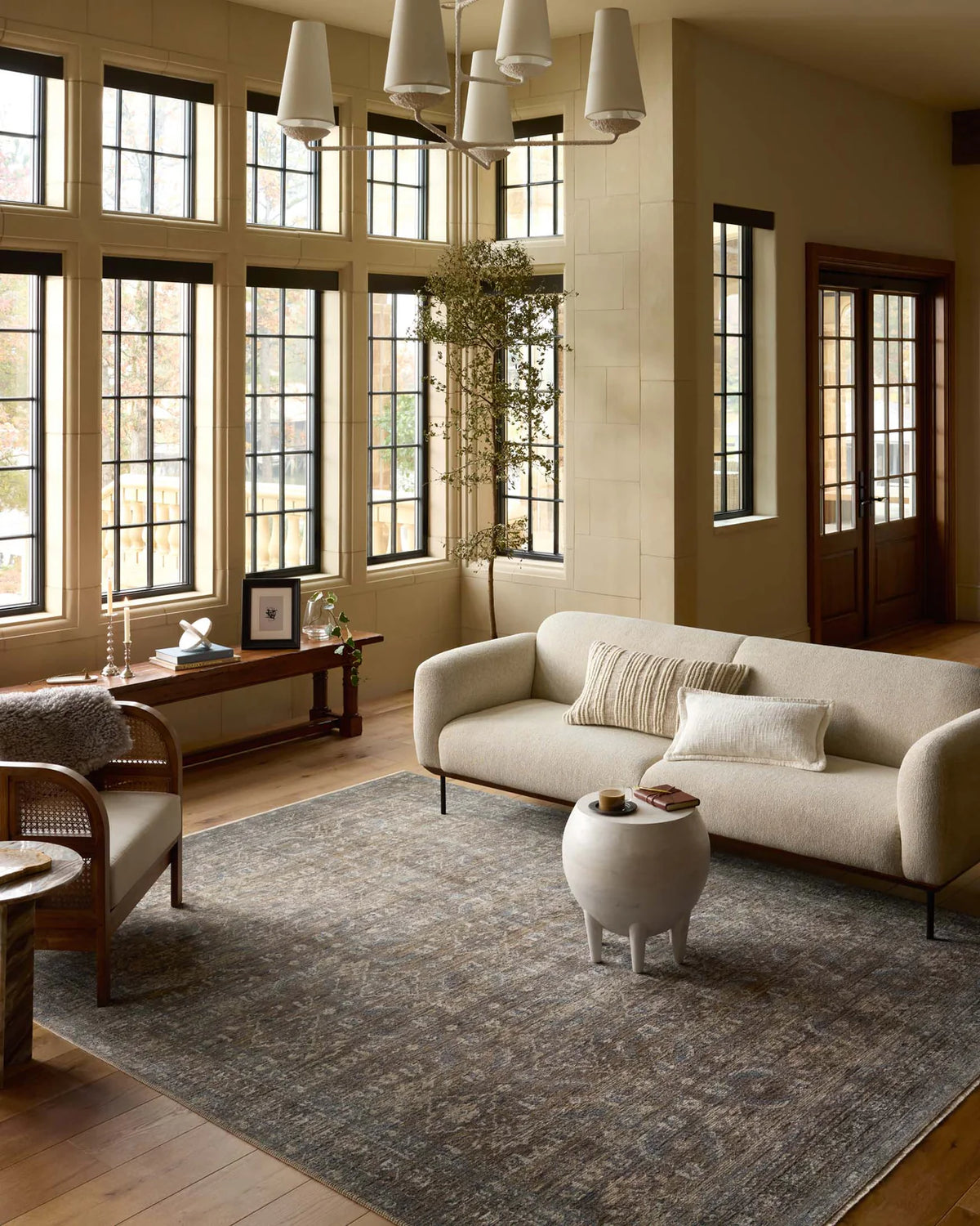 Vintage-style area rug with brown and blue tones, intricate floral pattern and distressed finish